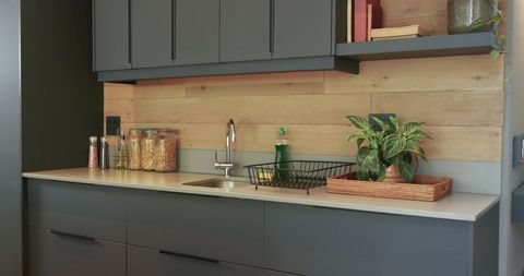 Minimalist kitchen interior with rustic wood paneling and modern fixtures