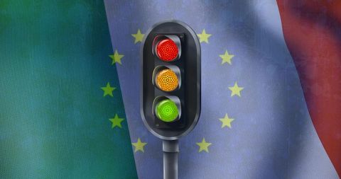 Traffic light standing against draped tricolor flags with european yellow stars