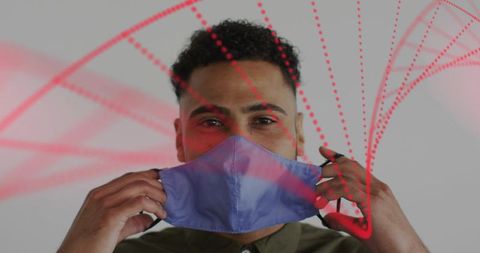 Man adjusting cloth face mask with red dotted arcs studio portrait for health safety