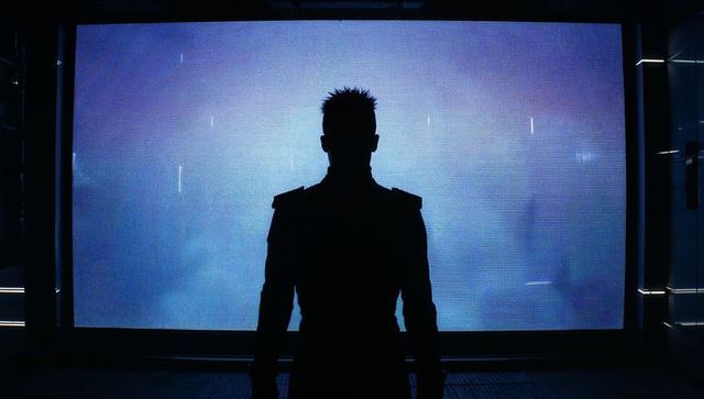Silhouette in high-tech control room with led wall