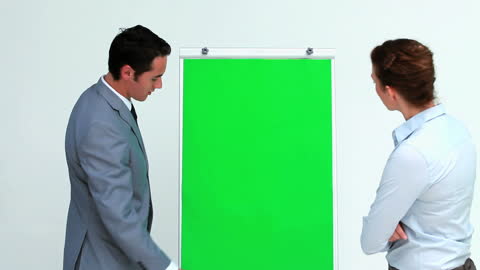 Business Meeting with Colleague Discussing on Presentation Board