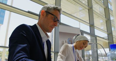 Diverse Professionals Focusing During Business Seminar in Bright Setting