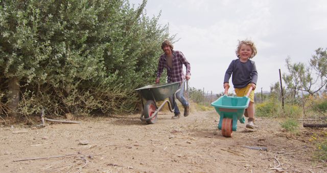 Father and Child Gardening Together with Wheelbarrows - Download Free Stock Images Pikwizard.com