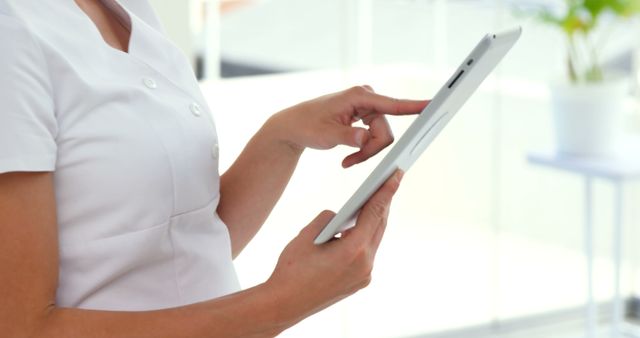 Nurse Using Tablet in Modern Clinic for Patient Records - Download Free Stock Photos Pikwizard.com