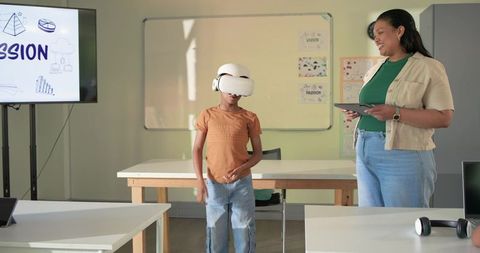 Student Exploring Virtual Reality in Classroom with African American Teacher Guiding