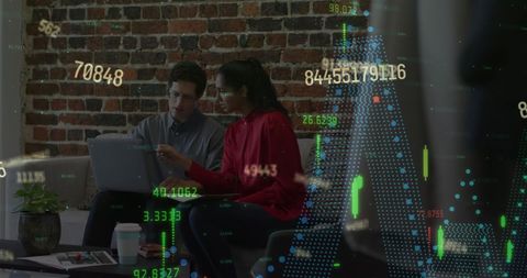 Colleagues analyzing financial data in office with digital interface