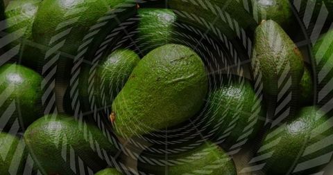 Close-up view of whole avocados with geometric overlay pattern