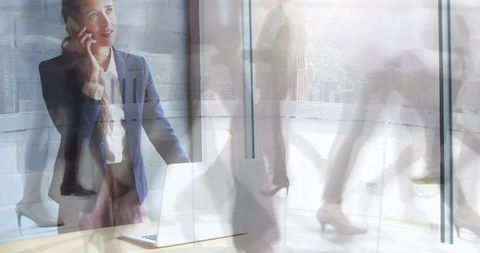 Businesswoman communicating amid city life motion blur