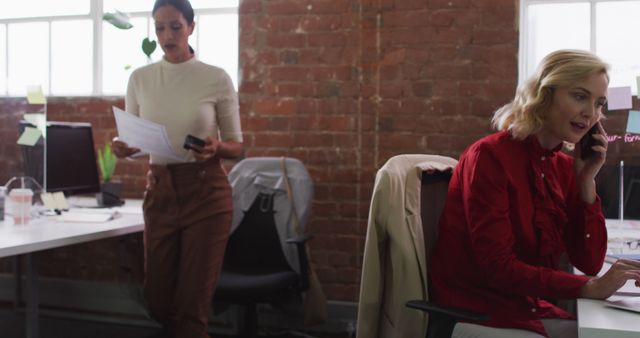 Businesswomen Working in Modern Office Layout with Brick Walls - Download Free Stock Images Pikwizard.com