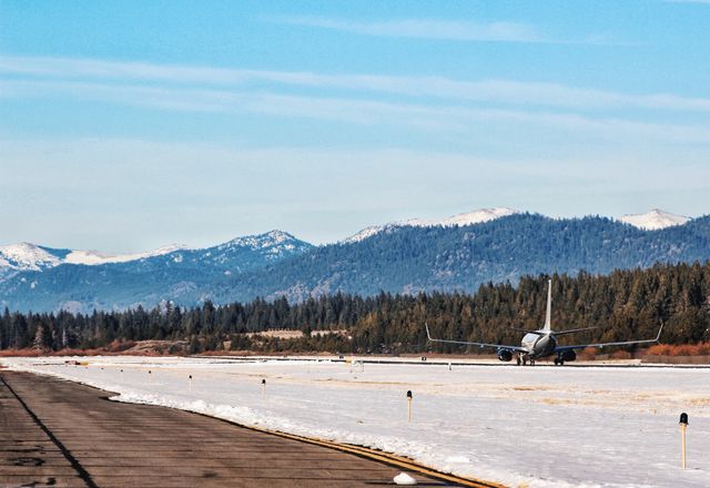 Airplane on Snow-Covered Runway with Mountain Landscape - Download Free Stock Photos Pikwizard.com