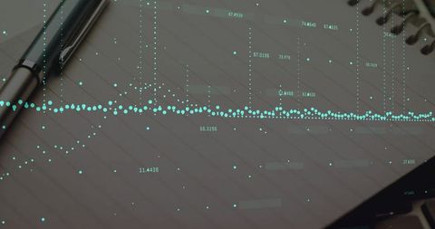 Displaying data overlay on spiral notebook with pen and laptop for business analytics