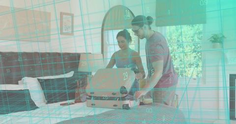 Couple packing suitcase on bed for trip, turquoise digital grid overlay, travel preparation