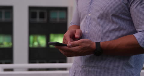 Businessman Using Smartphone in Modern Office Setting