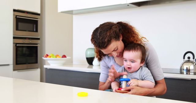 Caring Mother Feeding Her Curious Baby in Modern Kitchen - Download Free Stock Images Pikwizard.com