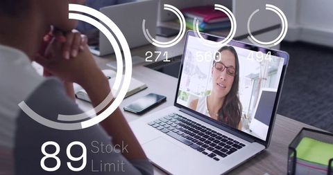 Watching remote team meeting on laptop with analytics overlays for hybrid collaboration