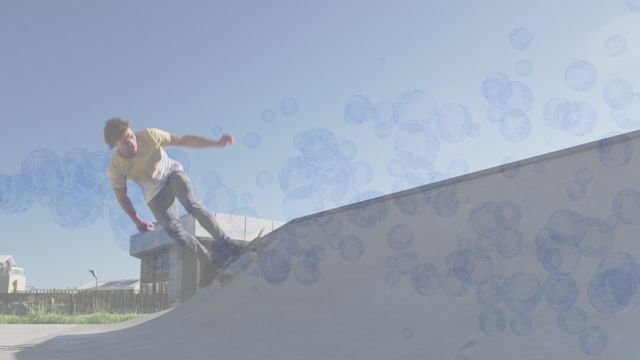 Skateboarder exhibiting lively tricks at skateboard park with a unique overlay of animated bubbles. Perfect for promoting skateboarding events, sports coaching, outdoor activities, and creative advertising related to action sports or youthful fun.