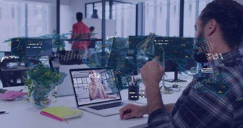 Man holding mug working on laptop with holographic world map overlay remote collaboration