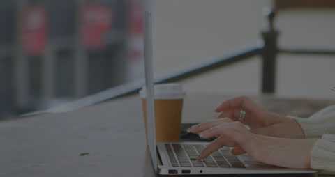 Hands Typing on Laptop with Animations Showcasing Data Processing