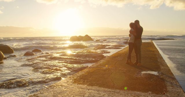 Romantic Couple Embracing at Ocean Sunset on Seaside Walkway - Download Free Stock Images Pikwizard.com