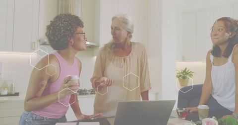 Multigenerational Women Collaborating Over Laptop in Bright Modern Kitchen Workspace