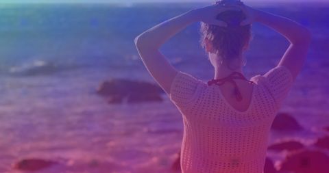 Serene Woman Enjoying Scenic Ocean View at Sunset