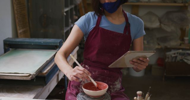 Female Potter Using Tablet While Working with Red Clay in Artisan Studio - Download Free Stock Images Pikwizard.com