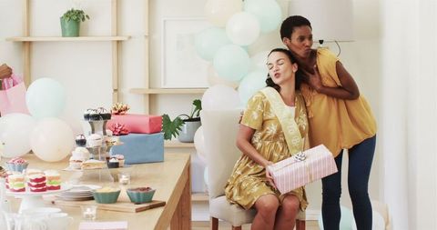 Joyful Home Celebration with Friends Exchanging Gifts