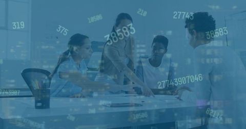 Diverse female professionals analyzing business data at office desk