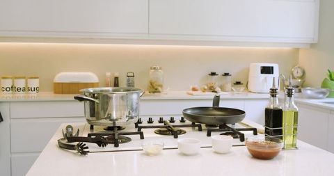 Modern kitchen island with cookware and prep bowls