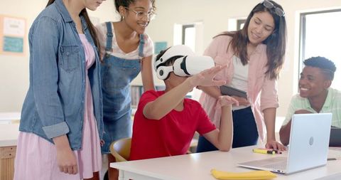 Diverse high school students engaging with virtual reality in classroom