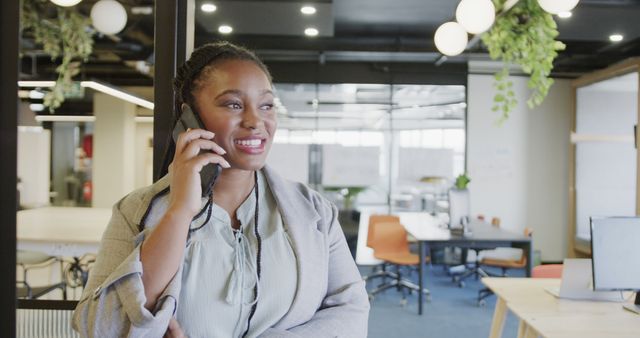 Businesswoman Talking on Phone in Modern Office Space - Download Free Stock Images Pikwizard.com