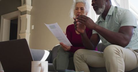 Senior Couple Reviewing Finances in Home Setting