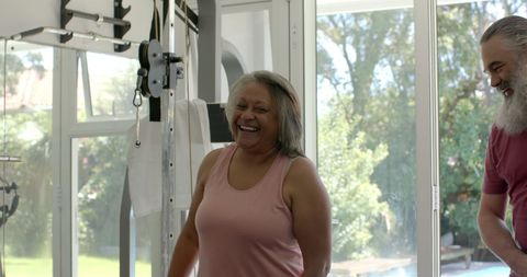 Senior couple exercising at home gym embracing a healthy lifestyle