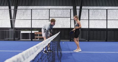 Friends Playing Paddle Tennis in Indoor Court