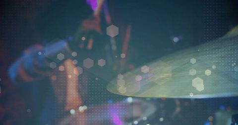 Close-up hitting cymbal with drumstick motion and hex overlay, stage lighting bokeh