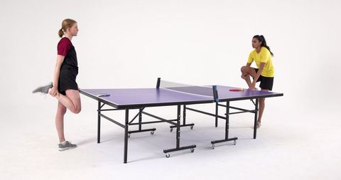 Diverse Female Athletes Preparing for Table Tennis Match