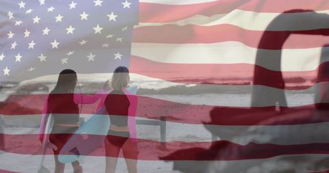 Patriotic surf adventure: two women walking toward ocean carrying surfboards, us flag overlay