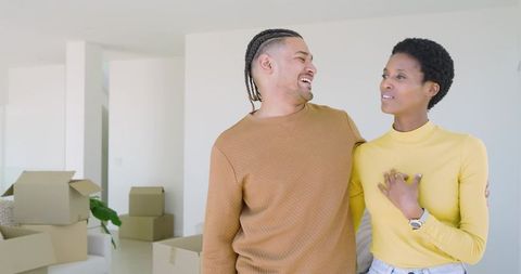 Happy diverse couple moving into modern living space