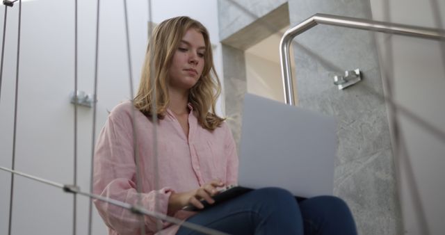 Young Woman Working on Laptop While Sitting on Steps - Download Free Stock Images Pikwizard.com