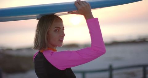 Woman with Surfboard at Sunset Beach - Download Free Stock Images Pikwizard.com