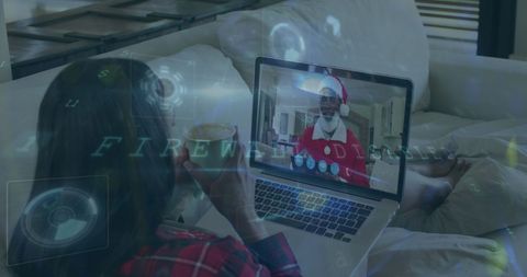 Woman enjoying virtual chat with santa claus on couch