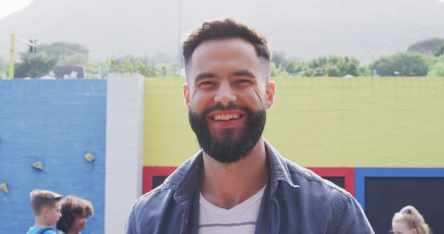 Smiling Bearded Man Outdoors in Urban Area with Colorful Wall - Download Free Stock Images Pikwizard.com