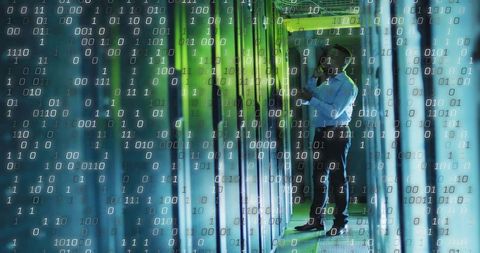 IT Technician Assessing Servers in Advanced Data Center