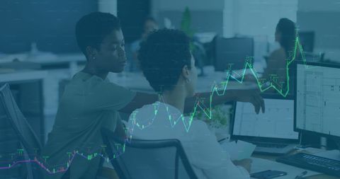 Diverse Female Coworkers Analyzing Business Data on Computers