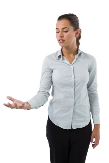 Female executive holding invisible object against white background