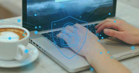 Secure Remote Work: Hands Typing on Laptop with Cybersecurity Shield Overlay and Coffee