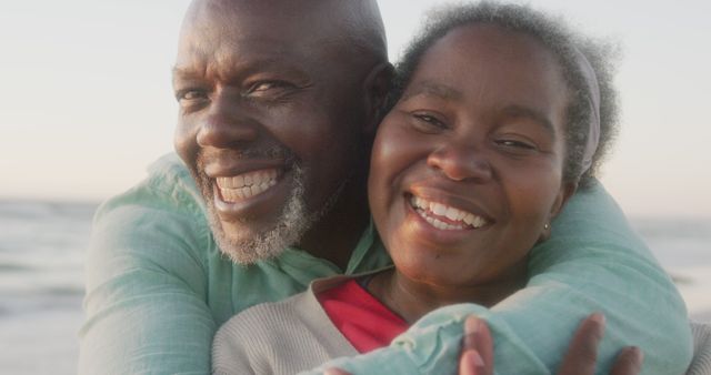 Joyful Senior Couple Embracing on Beach during Sunset - Download Free Stock Images Pikwizard.com