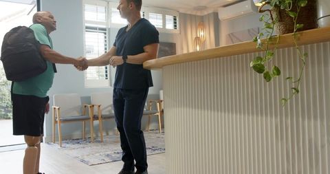 Medical professional welcoming prosthetic patient in clinic