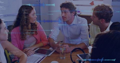 Team Collaborating and Discussing Data with Waveform Overlay in Conference Room