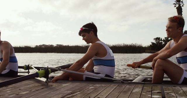 Rowing Team Preparing for Practice on Tranquil Lake - Download Free Stock Images Pikwizard.com